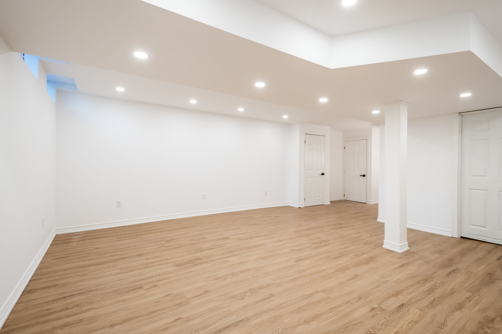 Bright finished basement with excellent recessed lighting and quality flooring — Stonehenge, Hamilton | MTC Renovations